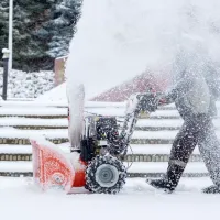 person plowing snow with a snow plow